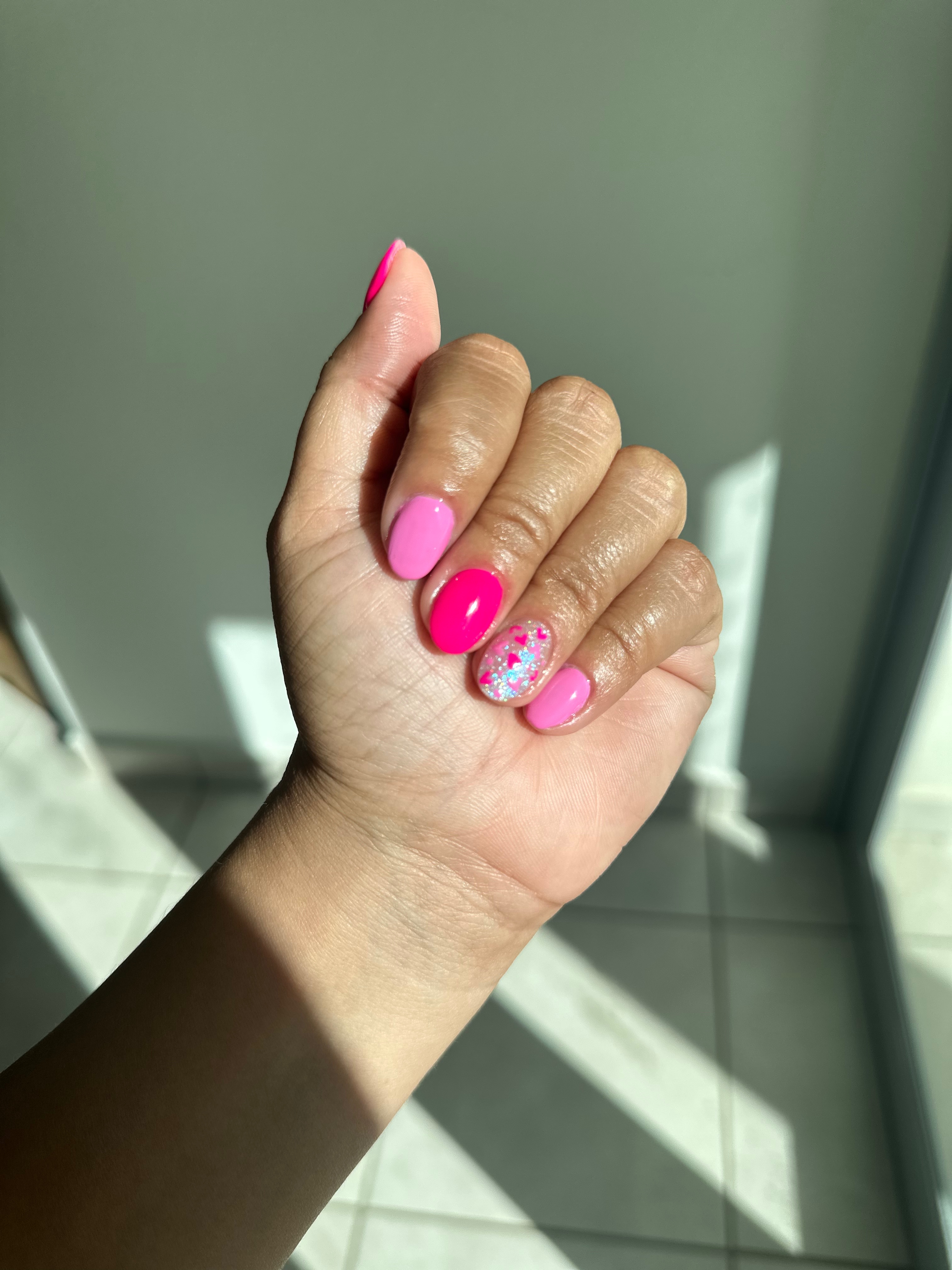 Pink color palette acrylic nail manicure with nail art.